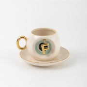 Turkish coffee cup & saucer, white with gold handle, teal letter F charm