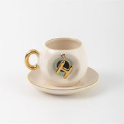 Turkish coffee cup & saucer, white with gold handle, teal letter H charm