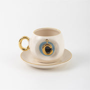 Ceramic Turkish coffee cup and saucer with gold handle, blue letter C charm