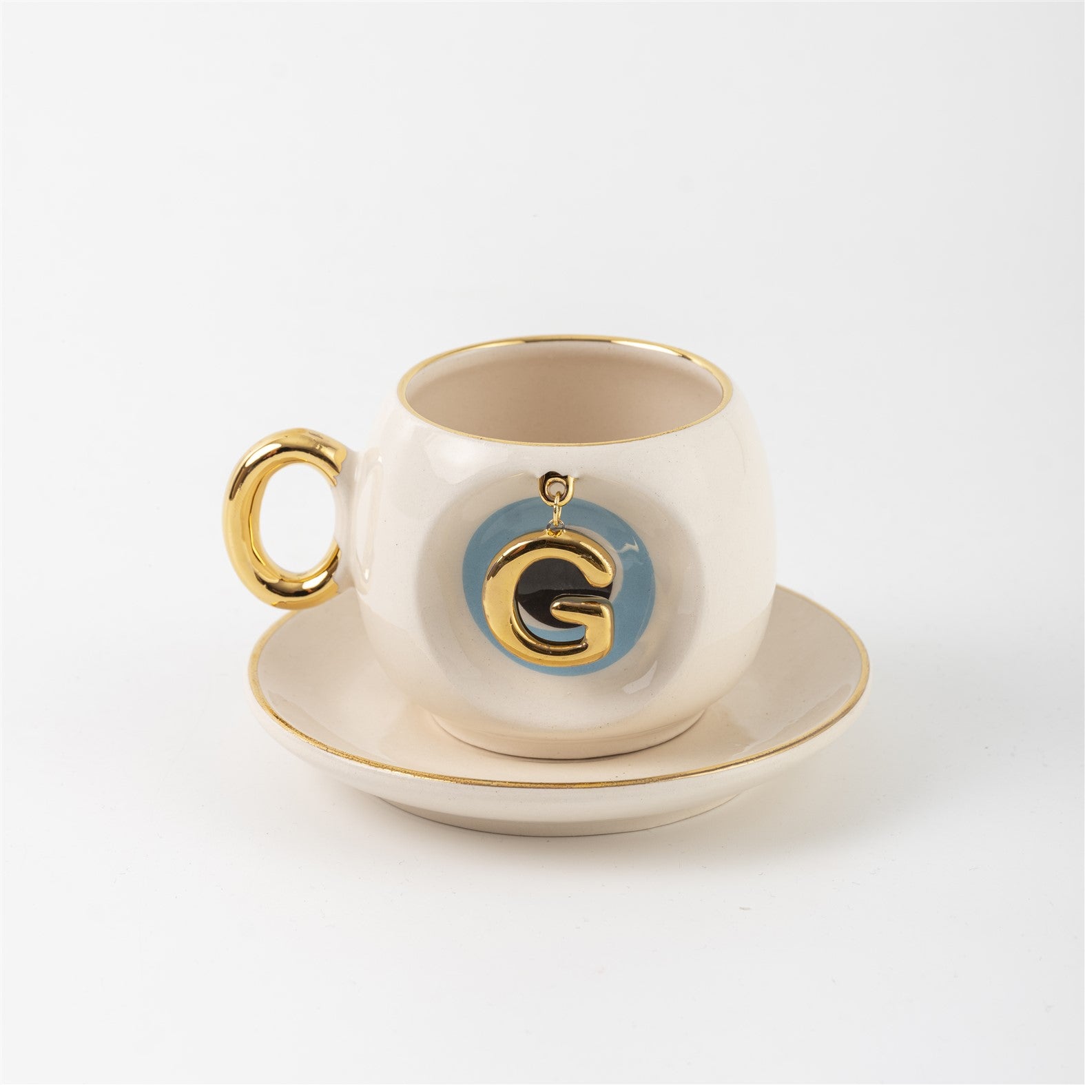 Ceramic Turkish coffee cup and saucer with gold handle, blue letter G charm