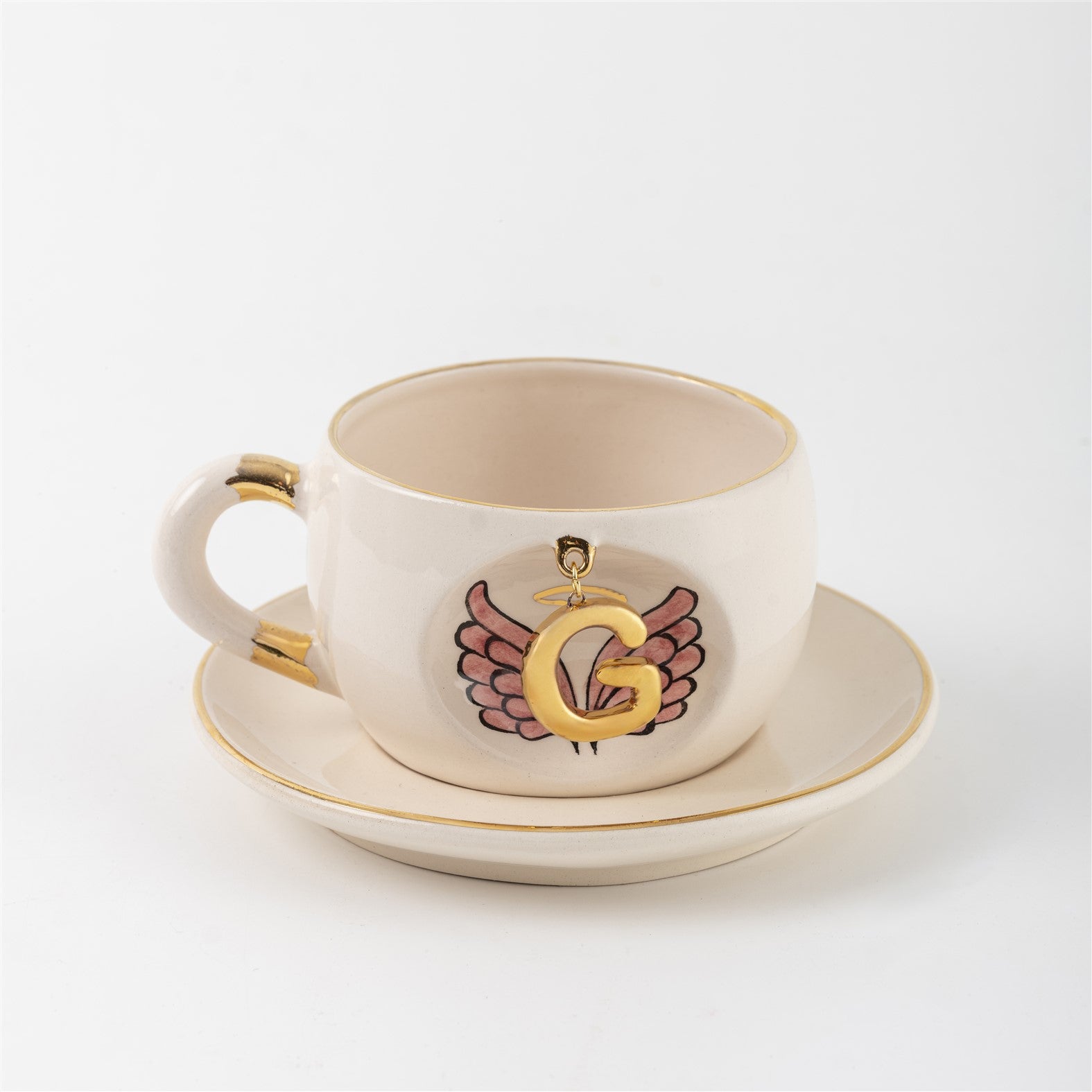 Porcelain cup and saucer set with gold trim, white finish, angel-wings letter emblem