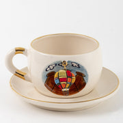 Cream ceramic hot air balloon mug with gold rim and central balloon graphic on cup front