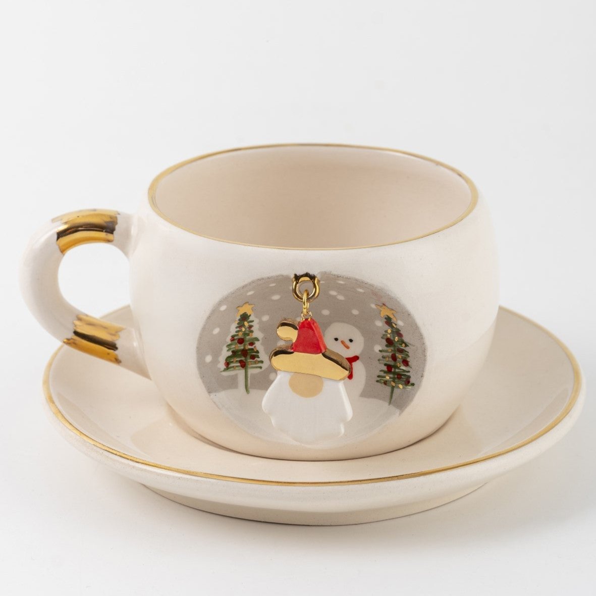 White tea mug and saucer with gold trim; Father Christmas ornament charm centered