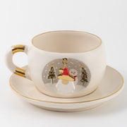 White tea mug and saucer with gold trim; Father Christmas ornament charm centered