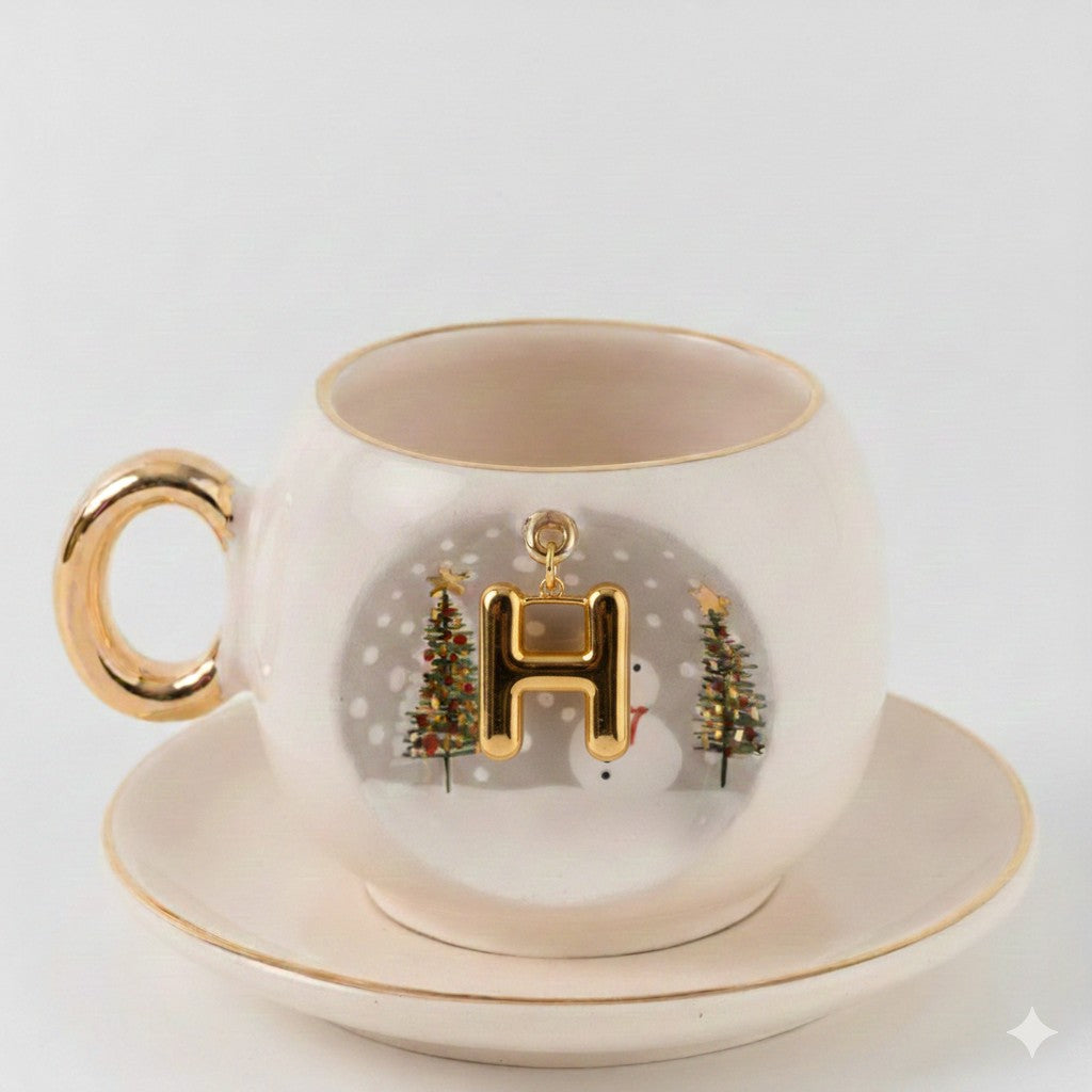 Porcelain coffee cup with saucer; gold letter H winter scene with snowman