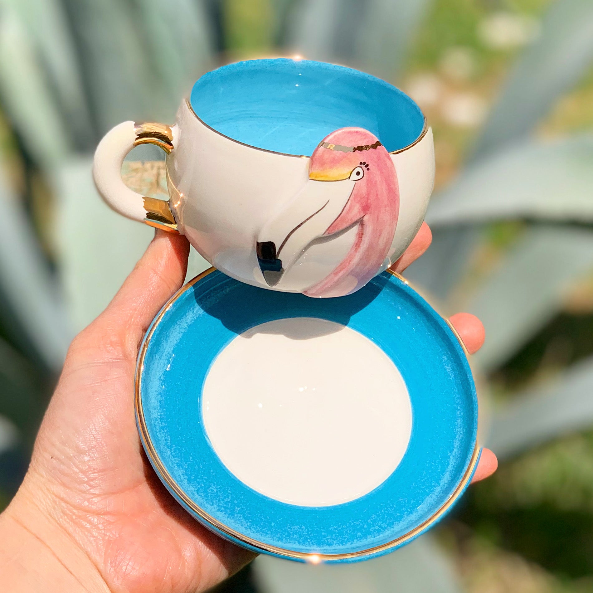 Flamingo tea mug with blue rim, pink flamingo graphic, matching saucer set