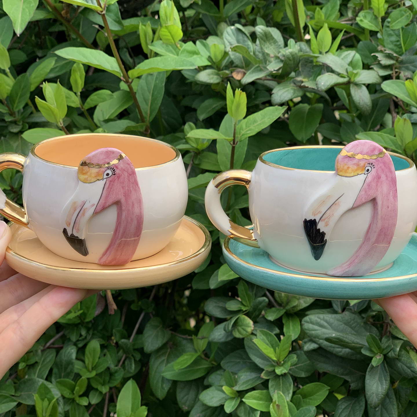 Set of flamingo tea mugs with matching saucers, one Nile green and one light