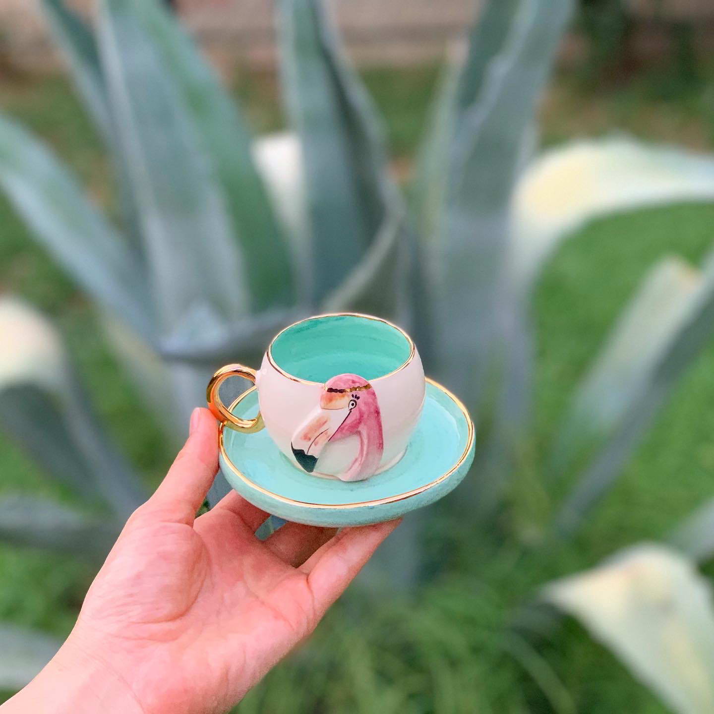 Nile green flamingo coffee cup with pink flamingo interior and matching saucer