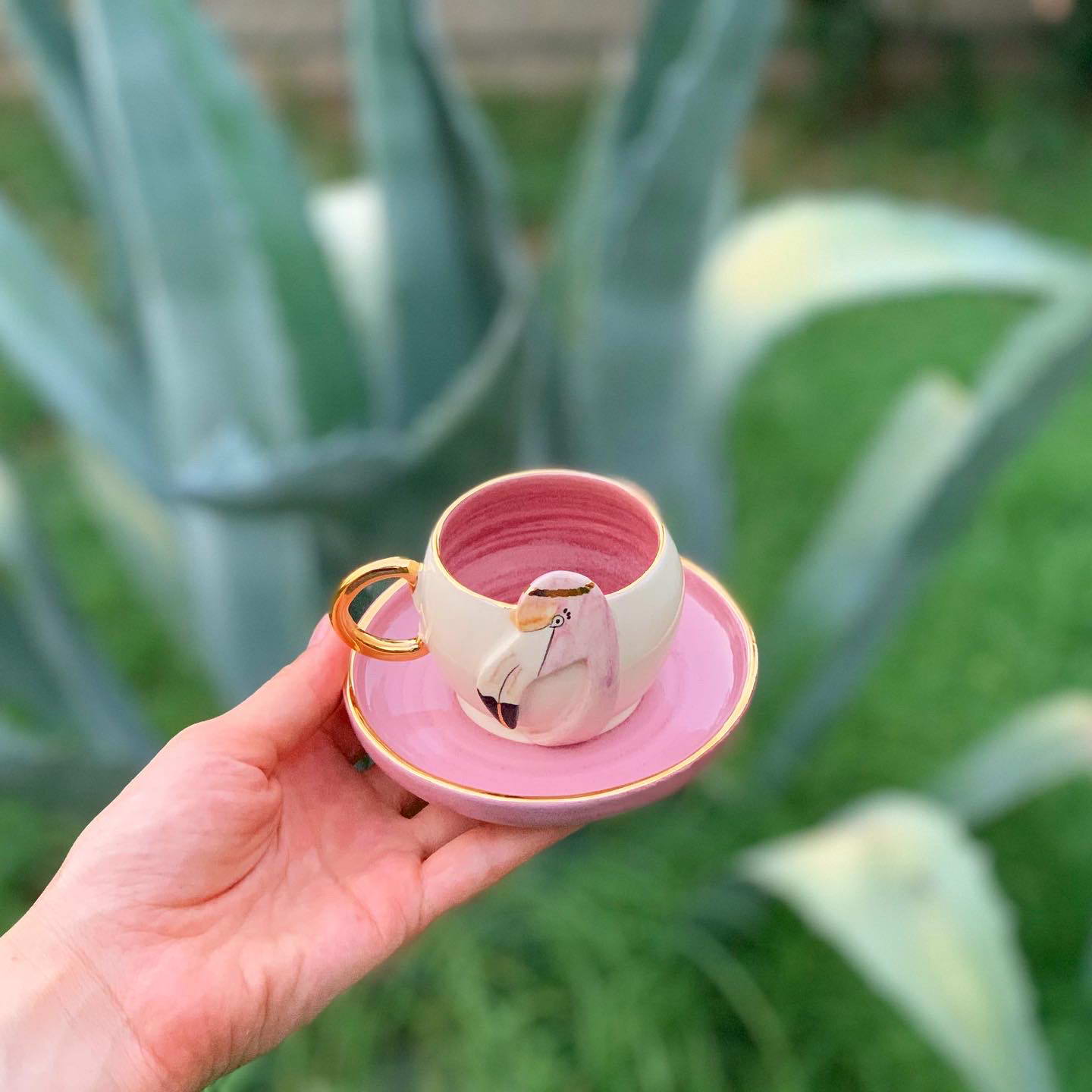 Pink flamingo coffee cup with saucer, gold handle and bird face detail
